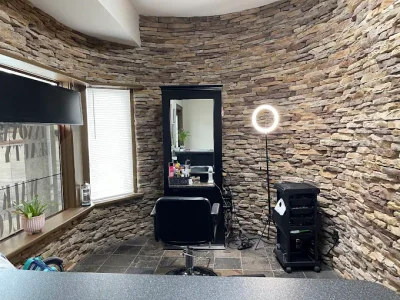 Salon styling station, stone wall, and sunlit window