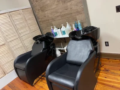 Salon shampoo chairs beside the stone feature wall